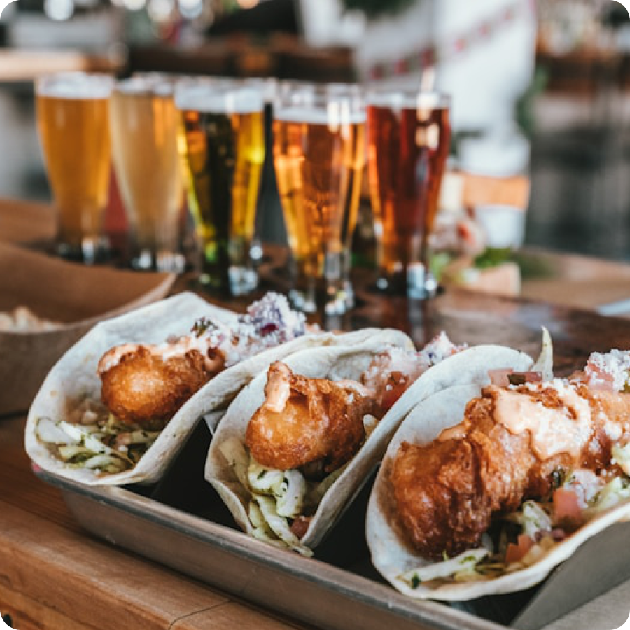 Bar food and beer flight on a wooden bar top