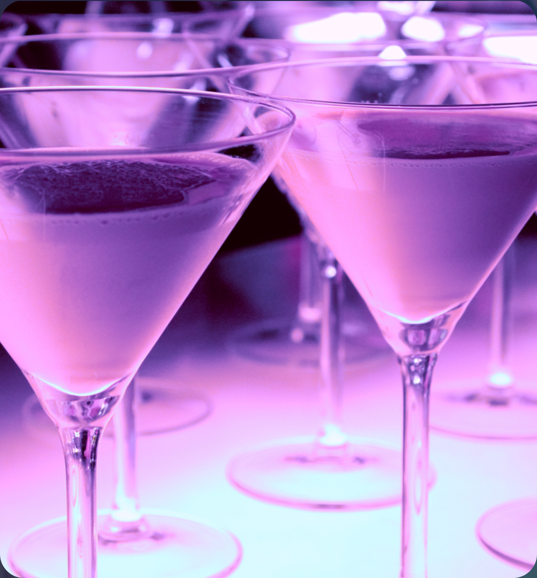 Neon-lit martini glasses at a club